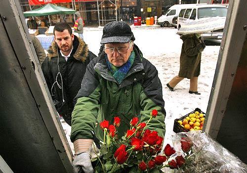 Michael Barry moves a bucket of roses out of the truck to make a sale on Valentine's Day. Barry is the last rose grower in New York state.