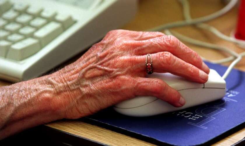 A woman uses a computer mouse.