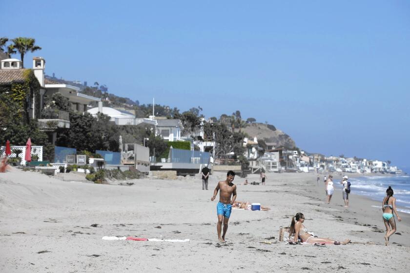 Beachgoers at Carbon Beach in Malibu, where a public pathway to the beach on the property of Lisette Ackerberg has been opened after a years-long dispute.