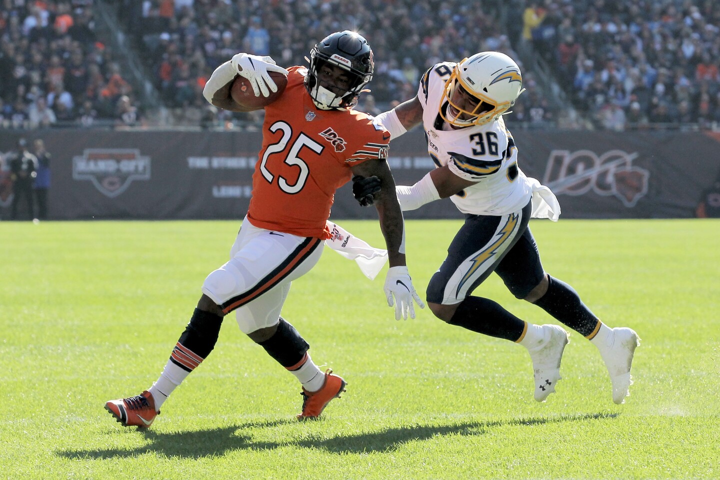 CHICAGO, ILLINOIS - OCTOBER 27: Mike Davis #25 of the Chicago Bears runs with the ball while being chased by Roderic Teamer #36 of the Los Angeles Chargers in the second quarter at Soldier Field on October 27, 2019 in Chicago, Illinois. (Photo by Dylan Buell/Getty Images)