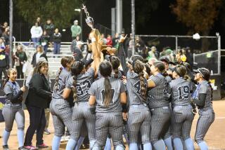 Carson players lift the championship trophy after capturing their second straight City Open Division title on Saturday night.