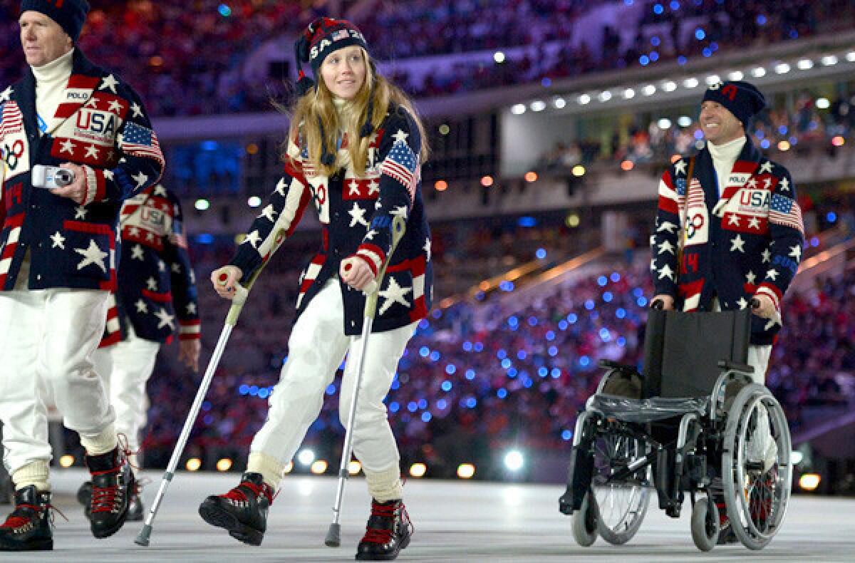Heidi Kloser walks with crutches as she parades with her delegation during the ppening ceremony of the Sochi Winter Olympics on Friday at Fisht Olympic Stadium.