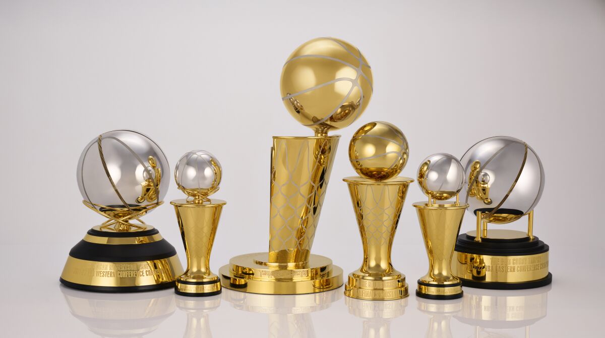This photo provided by the NBA shows a group of trophies. The NBA’s championship trophy has a new look, and the league is going to be handing out some new trophies for the first time during these playoffs. The league unveiled a redesigned Larry O’Brien Trophy on Thursday, May 12, 2022 plus announced changes to the Bill Russell NBA Finals MVP trophy and changes to the design of the conference championship trophies. (Jennifer Pottheiser/NBA via AP)