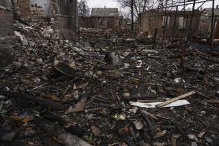 Ukrainian servicemen try to find undamaged shells in a burned-out ammunition depot which was destroyed after Russian attack near Kostiantynivka, Ukraine, Thursday, April 6, 2023. (AP Photo/Evgeniy Maloletka)