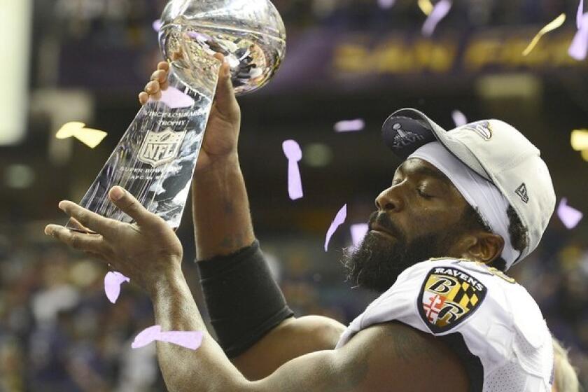 Ravens free safety Ed Reed holds aloft the Lombardi Trophy during the postgame celebration Sunday at the Superdome.