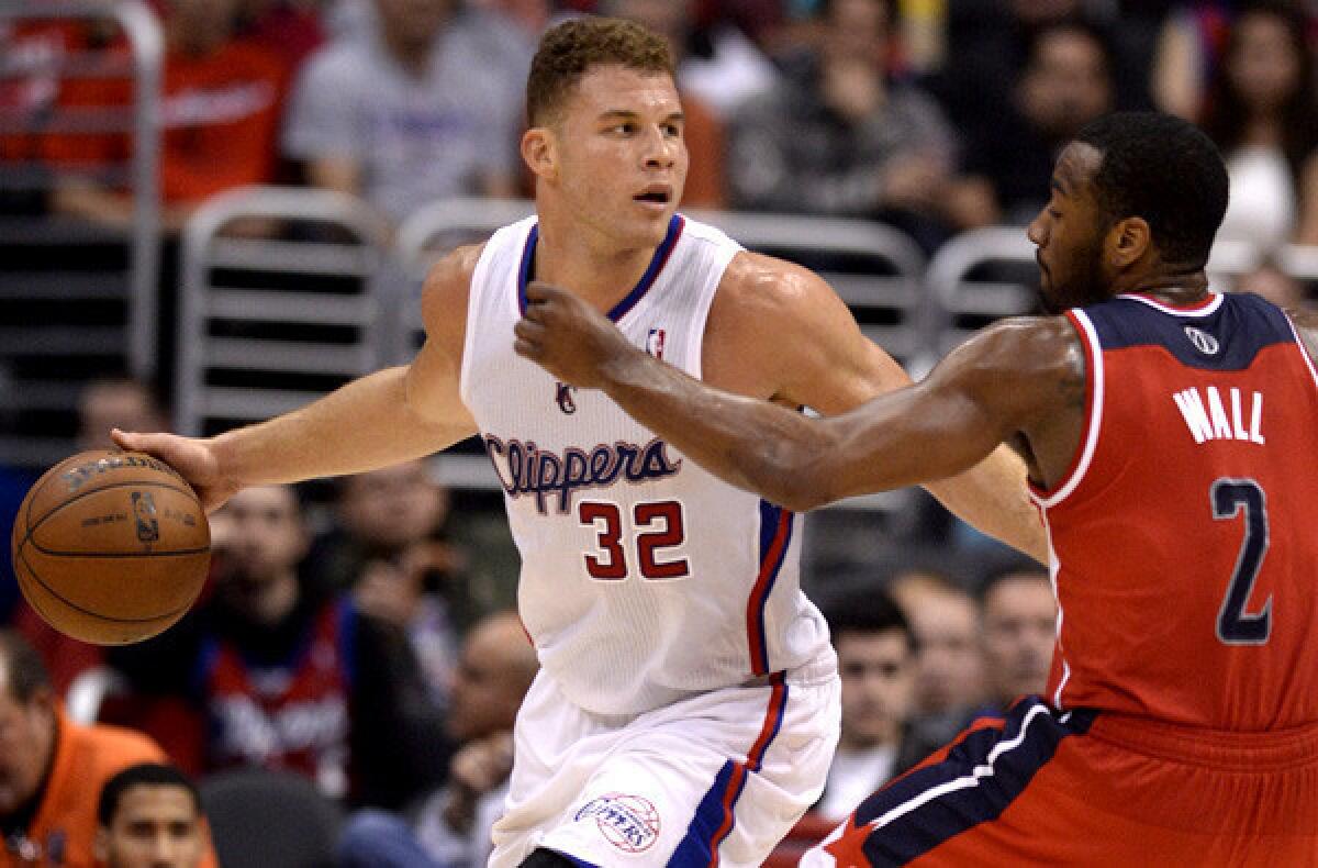 Clippers power forward Blake Griffin looks to drive against Wizards point guard John Wall during their game last week at Staples Center.