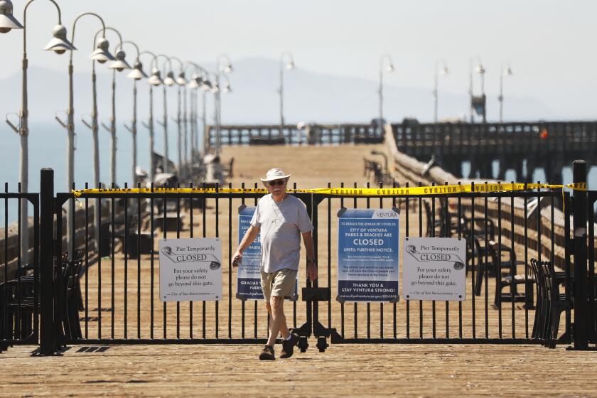 VENTURA, CA - APRIL 15: John Dodson, 69, takes his 3 and a half mile walk to the Ventura Pier in the City of Ventura Wednesday morning as the sunshine and warm temperatures brought people to the beach despite warnings about the coronavirus Covid-19 pandemic. Ventura on Wednesday, April 15, 2020 in Ventura, CA. (Al Seib / Los Angeles Times)
