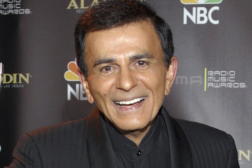FILE - In this Oct. 27, 2003, file photo, Casey Kasem poses for photographers after receiving the Radio Icon award during The 2003 Radio Music Awards at the Aladdin Resort and Casino in Las Vegas. Family members of radio personality Casey Kasem have settled a lawsuit against his widow that alleged her neglect and physical abuse led to his death in 2014. The two sides filed a joint request to have the case and a counter-suit, part of a legal battle over the late life and death of the longtime “American Top 40" host, dismissed in Los Angeles Superior Court on Monday. (AP Photo/Eric Jamison, File)