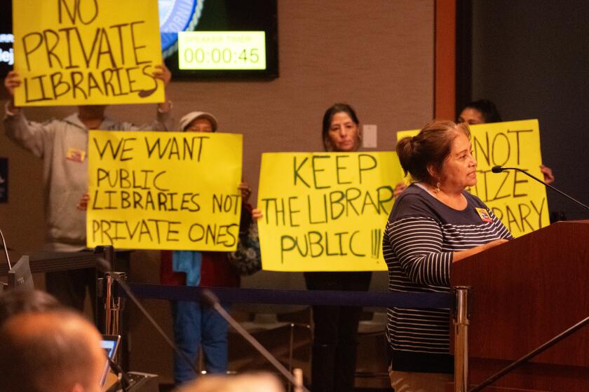 Alejandra Capistrana expresses support for Huntington Beach's libraries in Spanish during Tuesday's City Council meeting. As translated by relatives, she said her children and nephews relied on the library as a public resource, and opposed plans to privatize it.