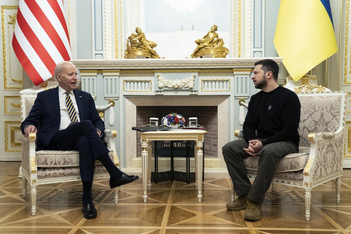 President Biden and Ukrainian President Volodymyr Zelensky seated across from each other
