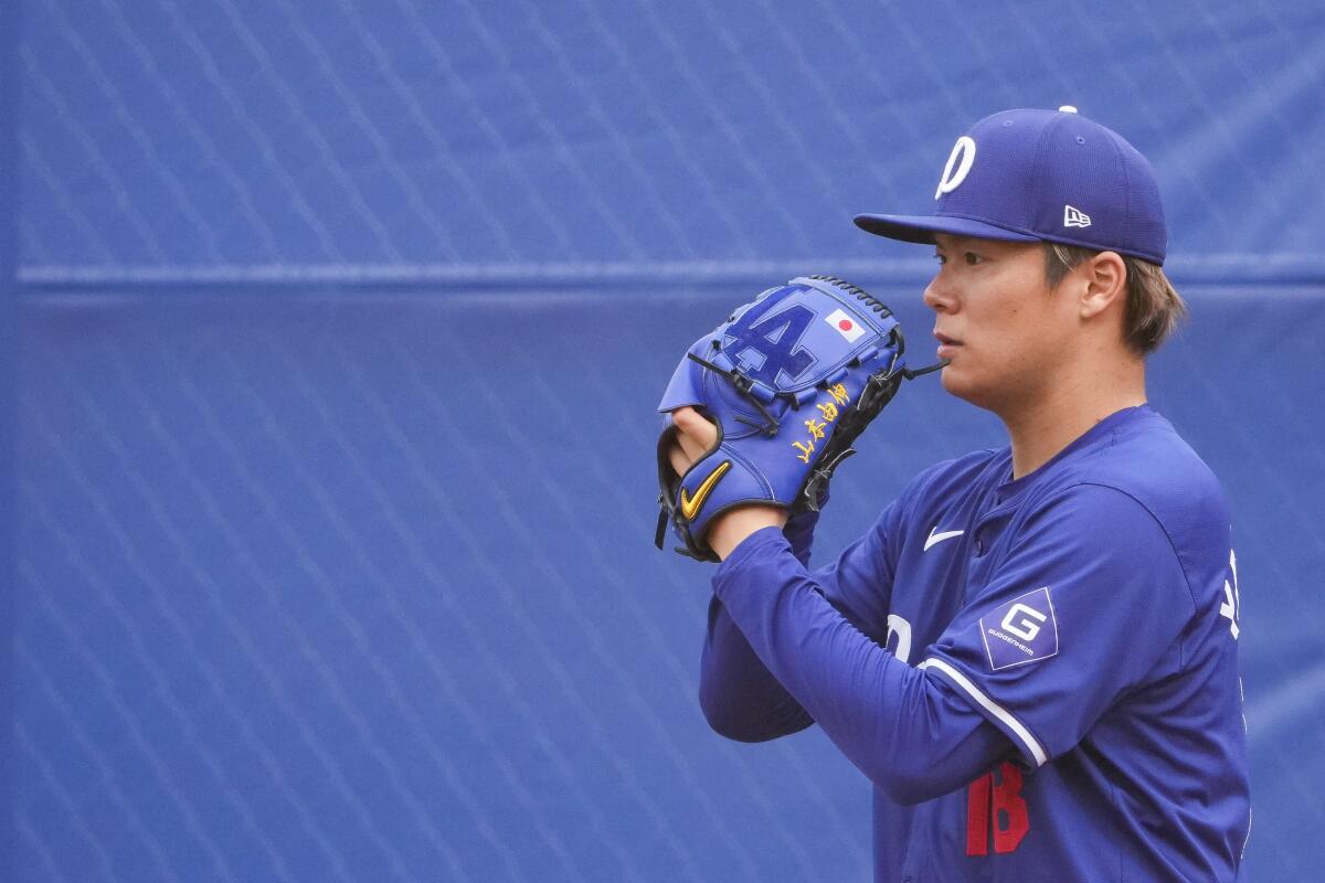 Dodgers pitcher Yoshinobu Yamamoto throws a bullpen session last month. 