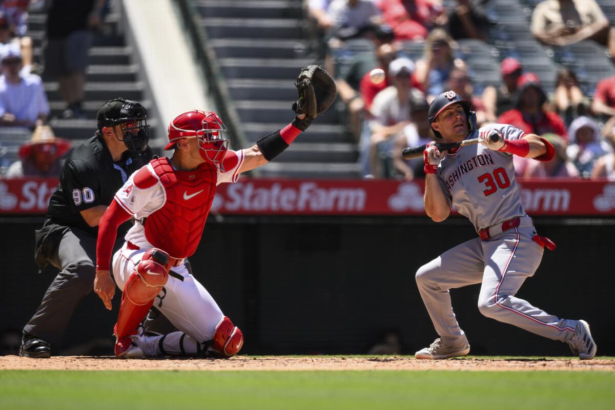 Nationals fielder Jacob Young avoids a pitch while trying to bunt during the fifth inning of a game against the Angels.