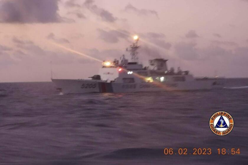 This photo provided by the Philippine Coast Guard shows a Chinese coast guard ship in the disputed South China Sea, Monday, Feb. 6, 2023. The Philippines on Monday, Feb. 13, accused a Chinese coast guard ship of hitting a Philippine coast guard vessel with a military-grade laser and temporarily blinding some of its crew in the disputed South China Sea, calling it a “blatant” violation of Manila’s sovereign rights. (Philippine Coast Guard via AP)
