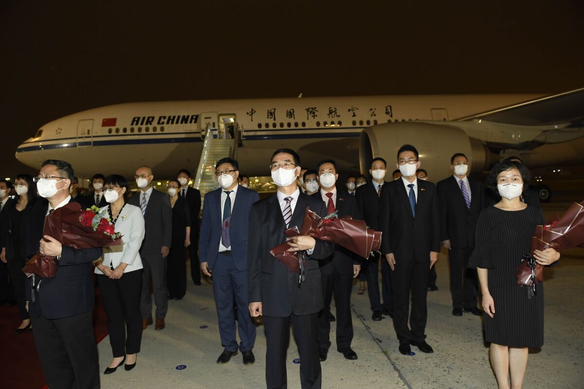 In this photo released by China's Xinhua News Agency, staff members from the Chinese Consulate in Houston, USA, arrive at an airport in Beijing, Monday, Aug. 17, 2020. A charter flight carrying employees of the consulate, which was ordered closed by the U.S. government in July amid escalating diplomatic tensions, arrived in Beijing on Monday night. (Yue Yuewei/Xinhua via AP)