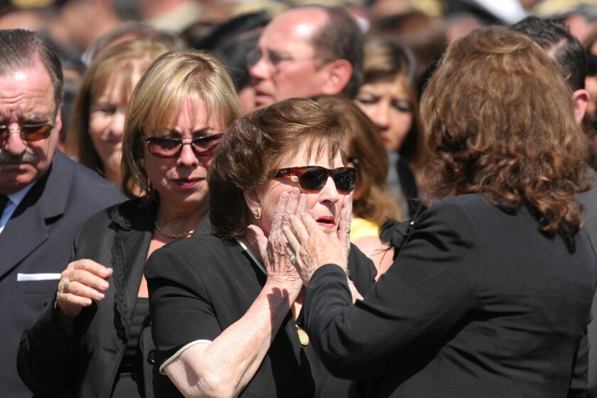 FILE - Lucia Hiriart de Pinochet, center, and her daughter Lucia are welcomed by a relative as they arrive to attend a mass during the funeral of her late husband, former dictator Gen. Augusto Pinochet at the Military Academy in Santiago, Dec. 12, 2006. Hiriart has died on Dec. 16, 2021. (AP Photo/Jorge Saenz, File)