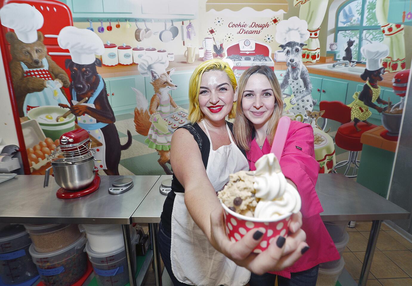 Sisters Danielle and Cara Friedman hold a cookie dough and ice cream cup in their kitchen at Cookie Dough Dreams, a one-month old and first of it's kind in Los Angeles County cookie dough parlor, in Burbank on Friday, July 13, 2018. Cookie dough that is good for everyone, with flavors like traditional chocolate chip and brownie batter, includes sugar-free, gluten-free, and vegan doughs that the Friedman sisters are quite proud of.