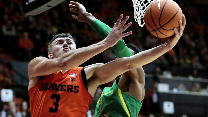 Oregon State's Tres Tinkle (3) gets to the basket past Oregon's Kenny Wooten (1) in the first half of an NCAA college basketball game in Corvallis, Ore., Friday, Jan. 5, 2018. (AP Photo/Timothy J. Gonzalez)