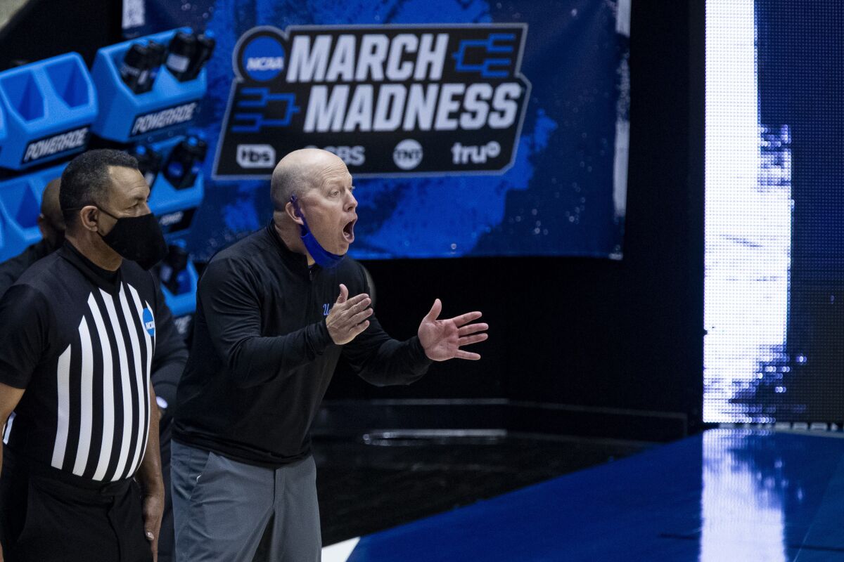 UCLA coach Mick Cronin instructs his players from the sideline.