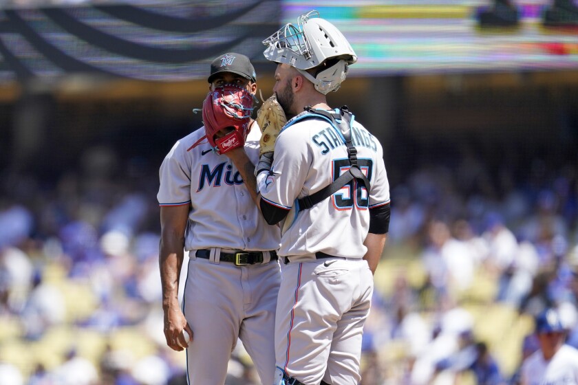 Miami Marlins starting pitcher Sandy Alcantara talks to catcher Jacob Stallings during Sunday's third inning.