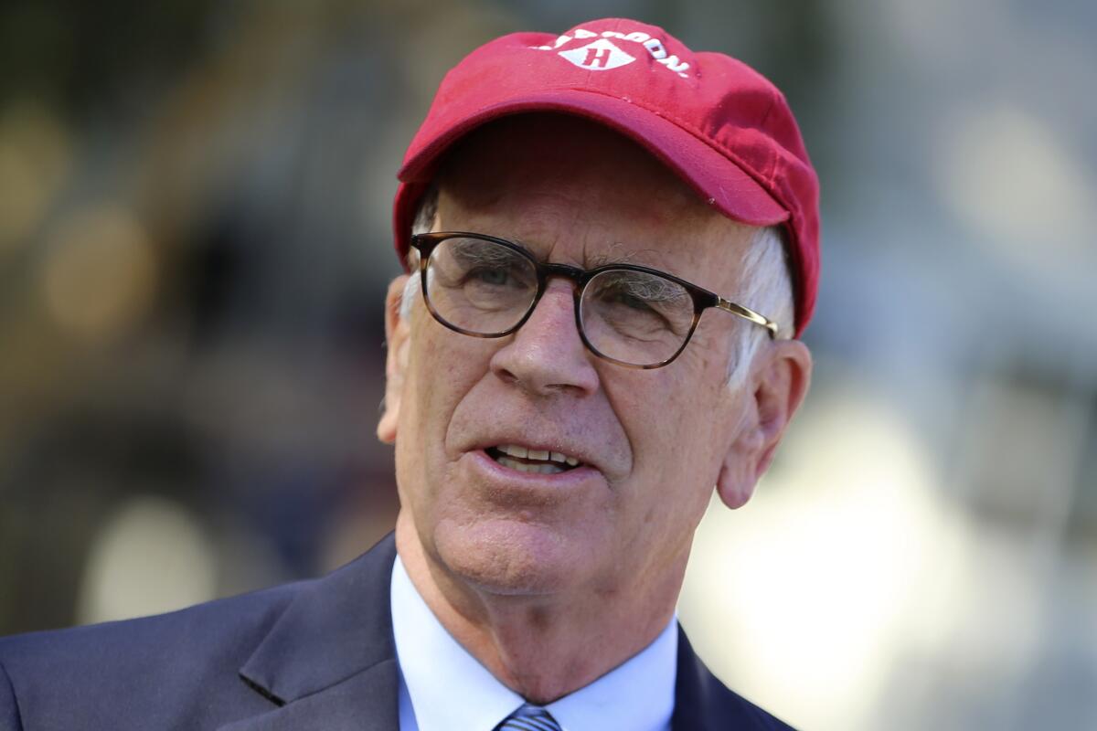 Rep. Peter Welch (D-Vt.), wearing a red hat, speaks at an event on Wednesday