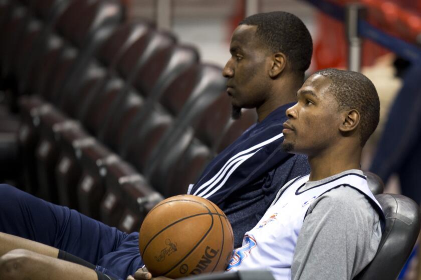 Oklahoma City Thunder Players Kevin Durant (R) and Kendrick Perkins attend a practice on June 20, 2012 at the American Airlines Arena in Miami, Florida. The Heat and the Oklahoma City Thunder are preparing for Game 5 of their NBA Finals scheduled for June 21, 2012. AFP PHOTO/DON EMMERT (Photo credit should read DON EMMERT/AFP/GettyImages)