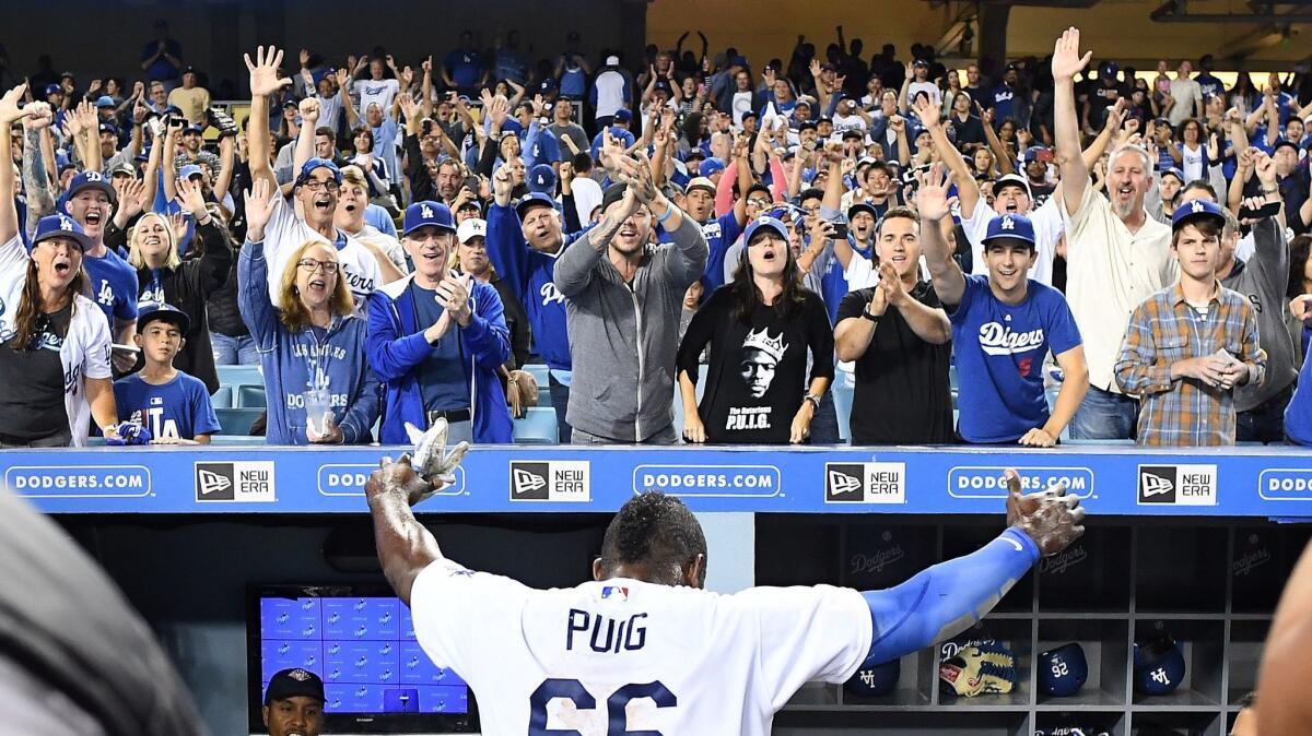 The Dodgers' Yasiel Puig celebrates with fans after a game-winning hit against the White Sox at Dodger Stadium.