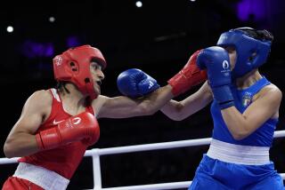 Algeria's Imane Khelif, left, fights Italy's Angela Carini in their women's 66kg preliminary boxing.