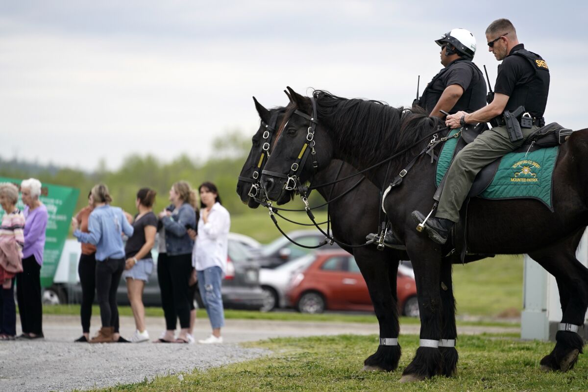 FILE -Officers on horseback guard the entrance to designated demonstrator areas near Riverbend Maximum Security Institution as people wait to enter before the scheduled execution of inmate Oscar Smith, Thursday, April 21, 2022, in Nashville, Tenn. Newly released records show at two least two people connected to a planned Tennessee execution that was abruptly put on hold April 21 knew the night before that the lethal injection drugs the state planned to use hadn’t undergone certain required testing. Last month, Gov. Bill Lee abruptly halted inmate Oscar Smith’s execution, citing an “oversight” in the execution process. (AP Photo/Mark Humphrey, File)