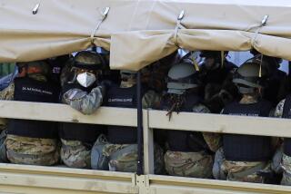 FILE - A member of the District of Columbia National Guard looks out from a vehicle driving on West Executive Avenue at the White House, Monday, June 1, 2020, in Washington, as demonstrators protest over the death of George Floyd nearby. U.S. officials say the Pentagon is developing plans to restructure the National Guard in Washington, D.C. The goal is to address problems highlighted by the chaotic response to the Jan. 6 riot and safety breaches during the 2020 protests over the murder of George Floyd. (AP Photo/Patrick Semansky, File)