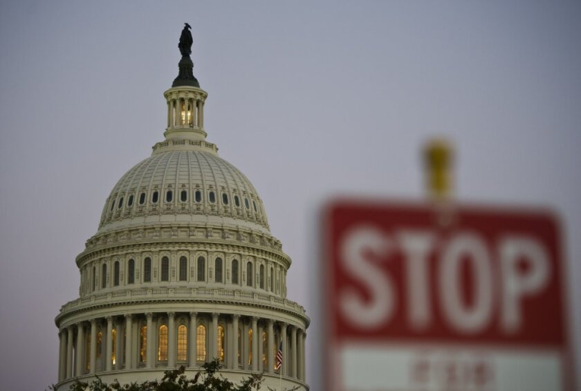 A stop sign is seen at dusk next to the U.S. Capitol building on the eve of the partial government shutdown that began earlier this week.