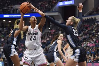 UConn's Aubrey Griffin (44) looks to shoot as Villanova's Maddie Burke (23) defends in the first half of an NCAA college basketball game, Sunday, Jan. 29, 2023, in Hartford, Conn. (AP Photo/Jessica Hill)