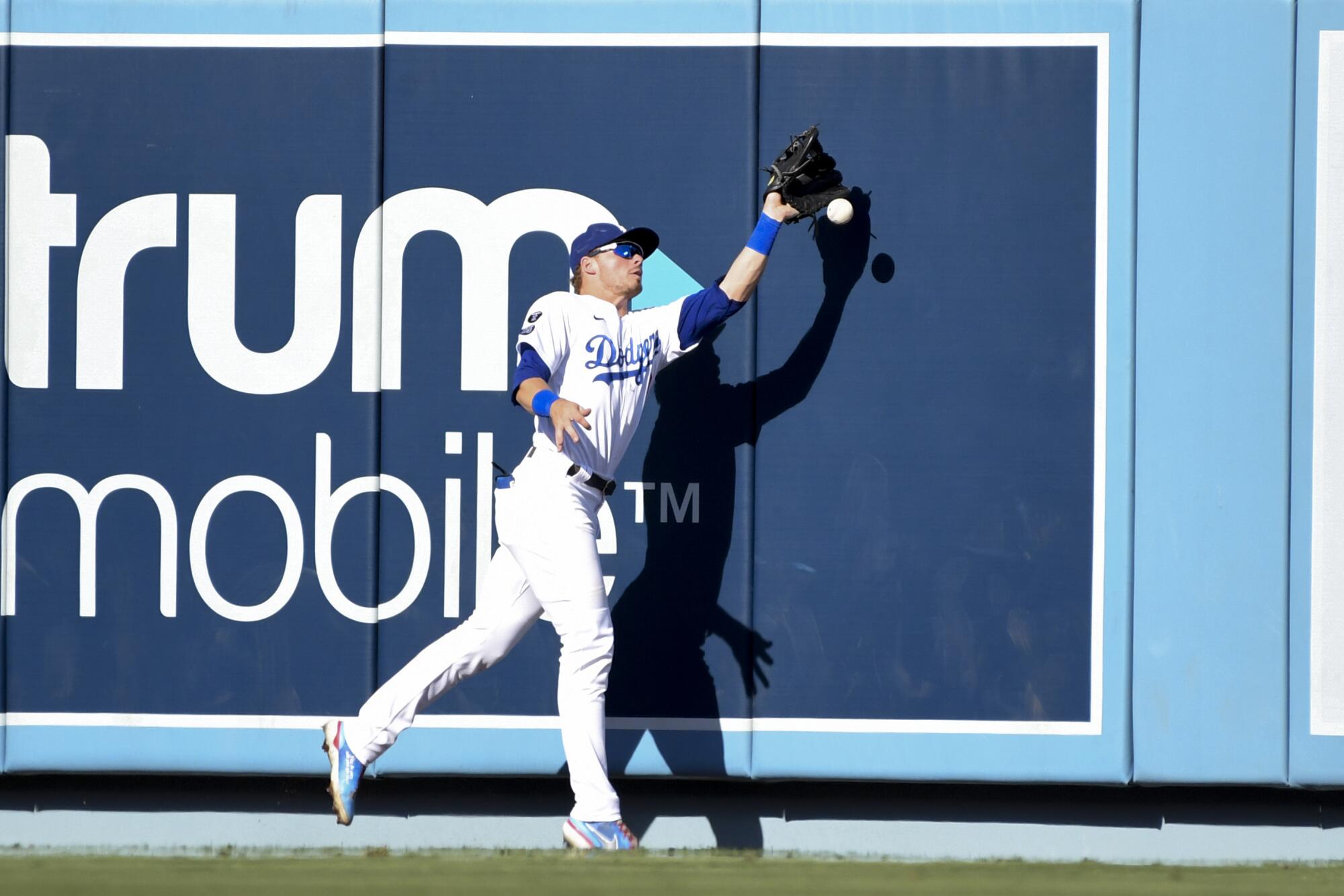 Dodgers' center fielder Gavin Lux is unable to catch a fly ball hit by Atlanta Braves' Austin Riley during the third inning.