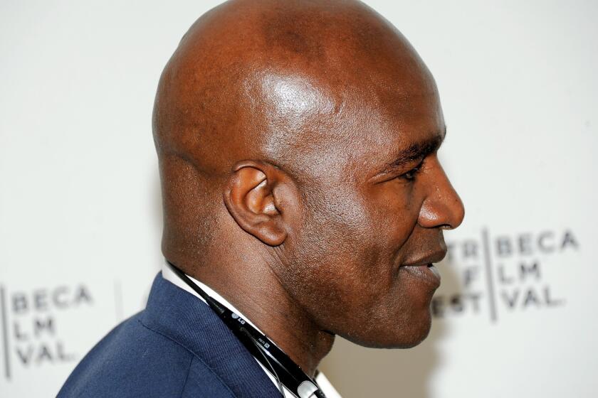 Retired heavyweight boxer Evander Holyfield displays a little less ear than he was born with. Holyfield, who had part of his ear bitten off by Mike Tyson in 1997, sympathizes with Dodgers infielder Alex Guerrero, who recently had a larger part of his ear bitten off by a teammate.