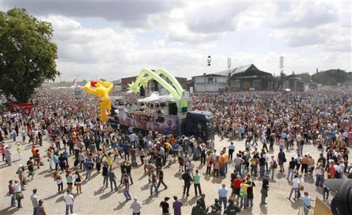 People celebrate this year's techno-music festival "Loveparade 2010" in Duisburg, Germany, on Saturday, July 24, 2010. German police say that 10 people were killed and 15 others injured when mass panic broke out in a tunnel at the Love Parade.(AP Photo/dapd/Photo/Hermann J. Knippertz)