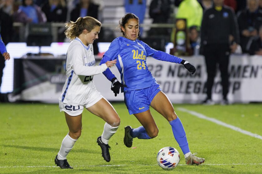 UCLA's Maricarmen Reyes (24) and North Carolina's Libby Moore race to a ball during the NCAA women's soccer tournament final in Cary, N.C., Monday, Dec. 5, 2022. (AP Photo/Ben McKeown)