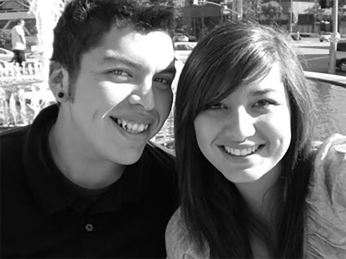 A man and young woman smile as they pose for a photo.