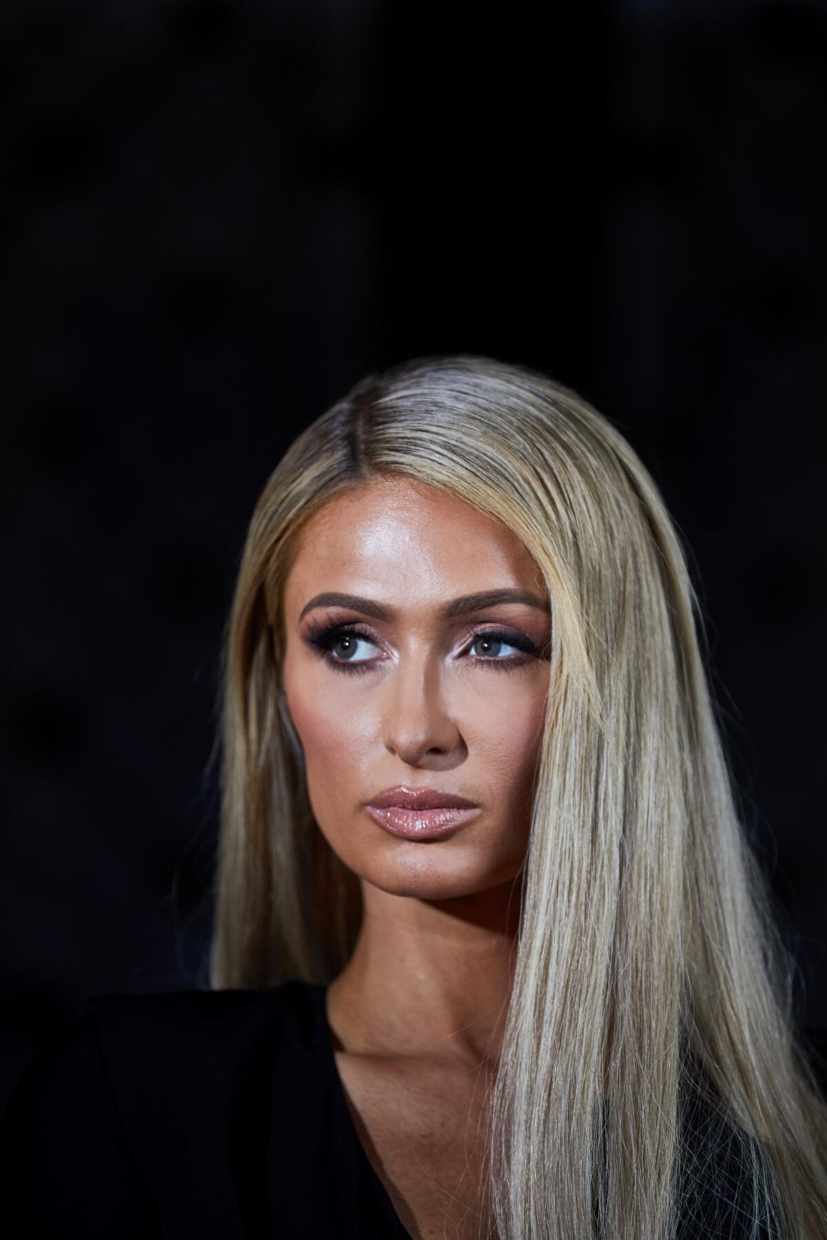 Close-up of a blond woman looking off to the side. 