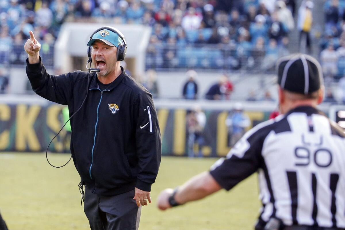 Jaguars Coach Gus Bradley argues a call with line judge Mike Spanier (90) during the first half of a game against the Falcons.