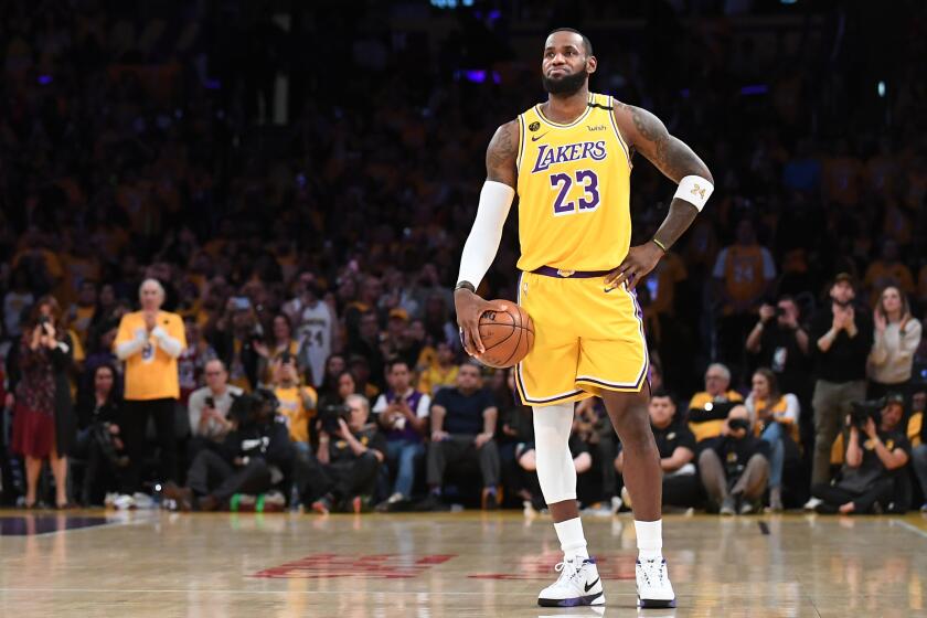 LeBron James holds the ball and lets the 24-second clock expire as a tribute to Kobe Bryant to begin a game against the Trail Blazers on Jan. 31 at Staples Center.