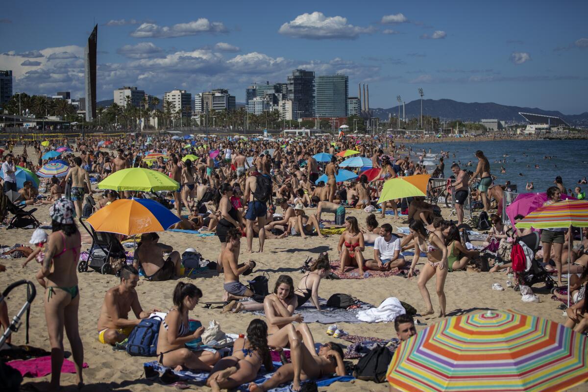 People crowd a beach in Barcelona, Spain, on June 13