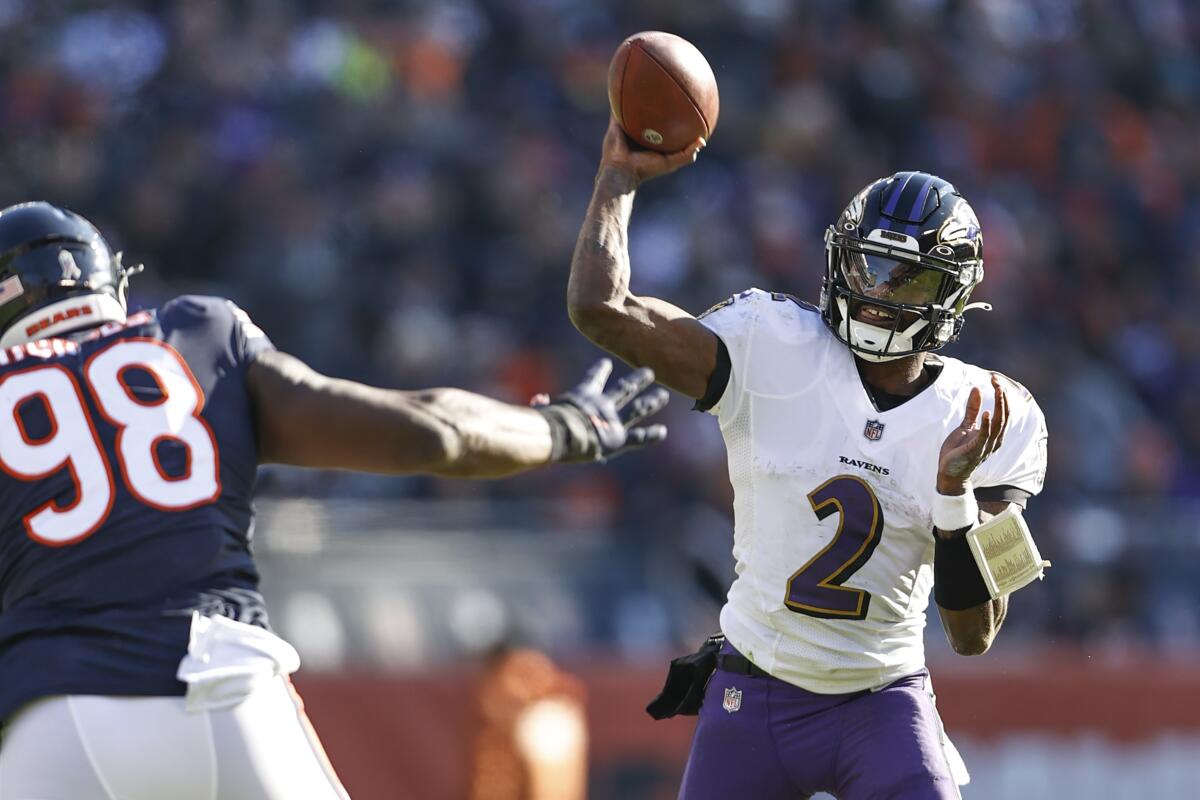 Baltimore Ravens quarterback Tyler Huntley looks to pass the ball.