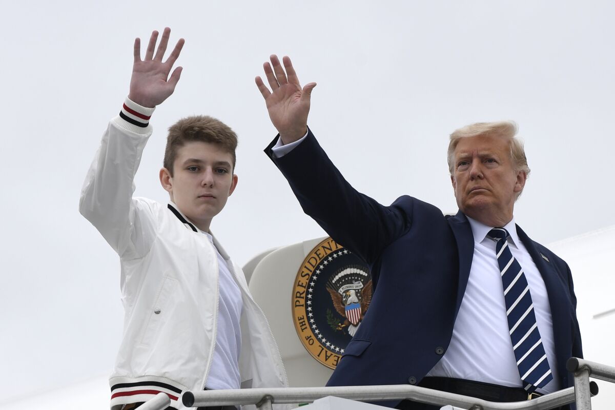President Trump and his son Barron wave from the top of the steps to Air Force One