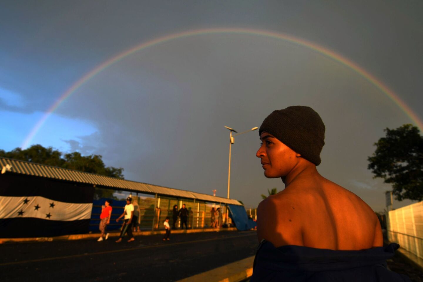 A Honduran migrant in a caravan toward the U.S. waits to cross the border from Ciudad Tecun Uman, Guatemala, to Ciudad Hidalgo, Mexico.