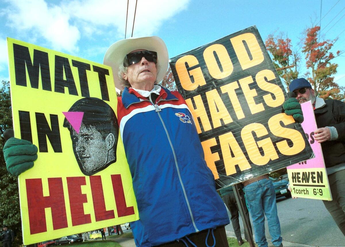 The Rev. Fred Phelps of Westboro Baptist Church protests in October 1999 about a meeting between the Rev. Jerry Falwell and the Rev. Mel White in Lynchburg, Va. Falwell met with White and other gay Christians in an attempt to reduce violent acts against both groups.