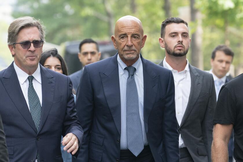 Tom Barrack, center, arrives at Brooklyn federal court, Monday, July 26, 2021, in New York. Barrack was among three men charged in New York federal court with trying to influence foreign policy while Donald Trump was running in 2016 and later while president. The chair of former President Donald Trump's 2017 inaugural committee allegedly conspired to influence U.S. policy to benefit the United Arab Emirates, even while he was seeking a position as an American diplomat. (AP Photo/Mark Lennihan)