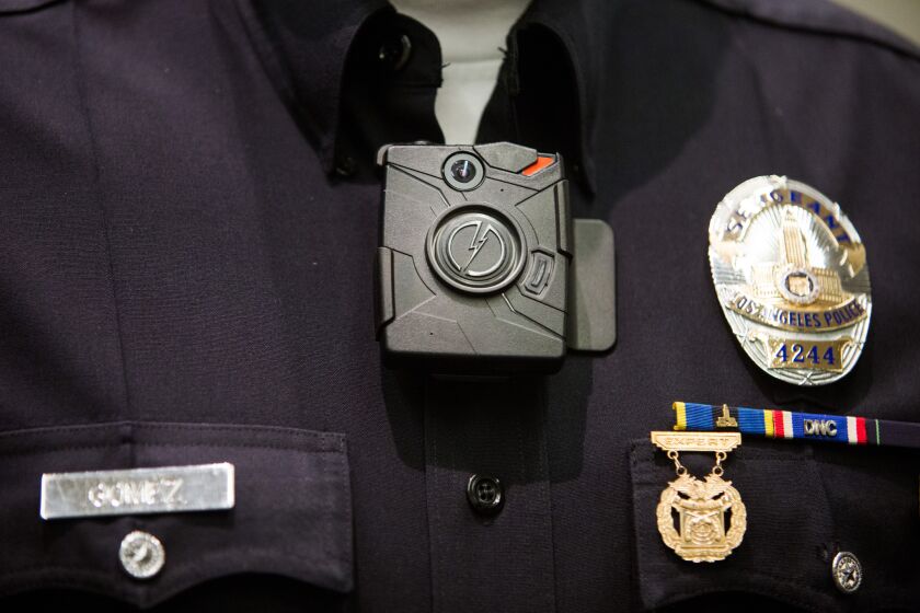 An LAPD officer wears a Taser Axon on-body camera during a press conference last December. At the event Mayor Eric Garcetti announced that the city would purchase 7,000 body cameras for police officers.