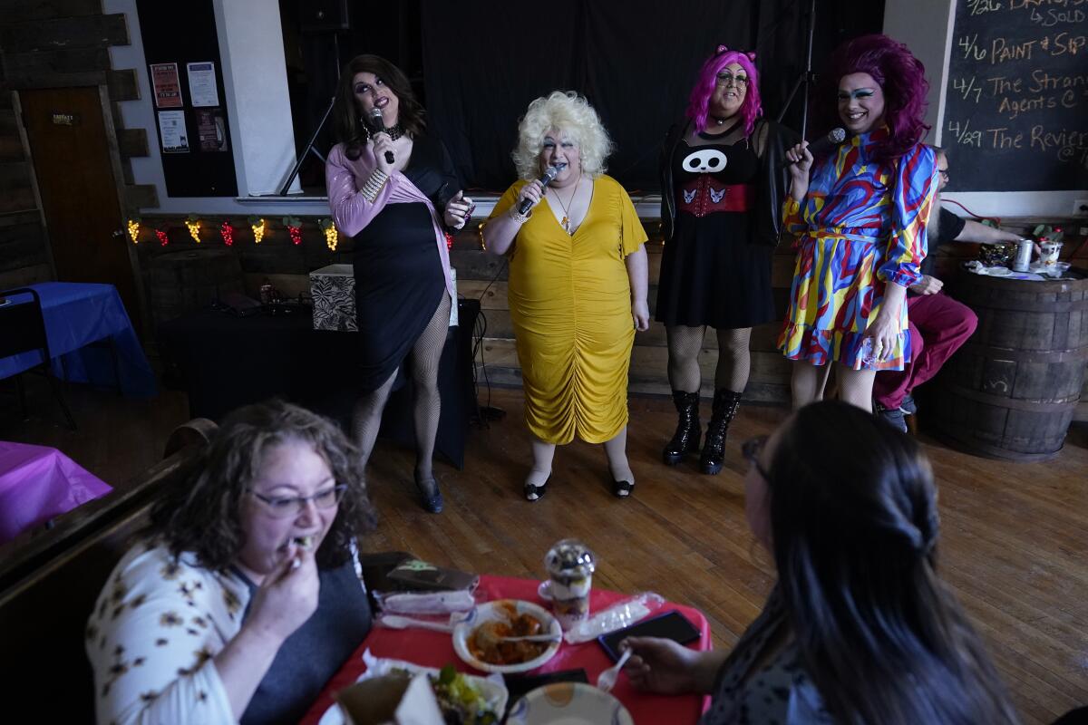 Drag queens talk to an audience during a brunch.