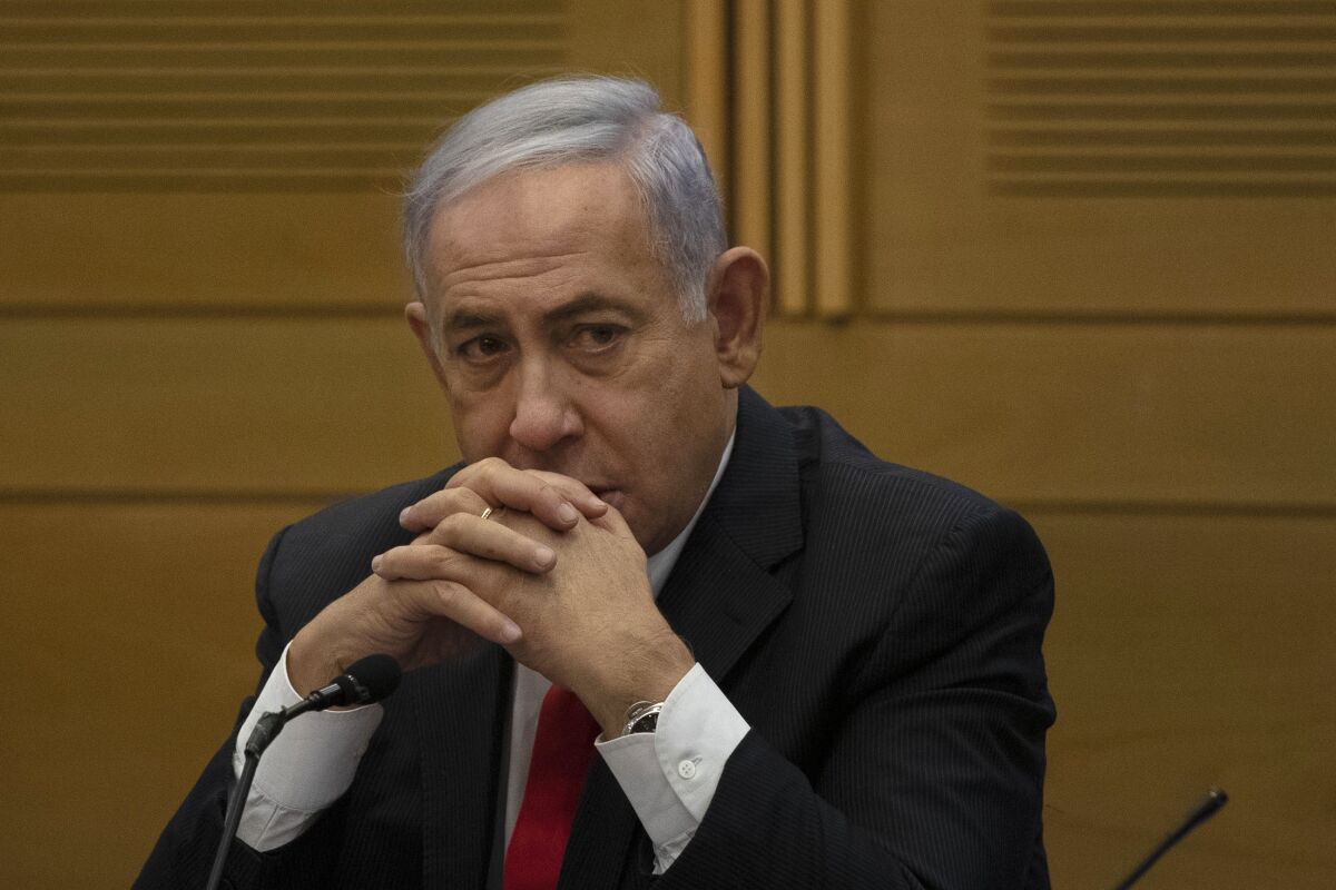 Former Israeli Prime Minister Benjamin Netanyahu speaks to right-wing opposition party members a day after a new government was sworn in, at the Knesset, Israel's parliament, in Jerusalem, Monday, June 14, 2021. (AP Photo/Maya Alleruzzo)