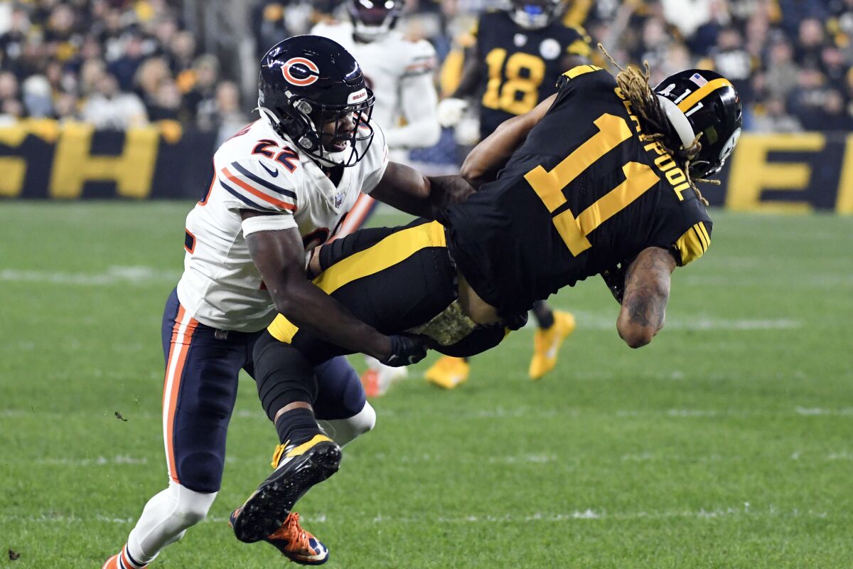 Pittsburgh Steelers wide receiver Chase Claypool (11) is tackled by Chicago Bears cornerback Kindle Vildor (22) after making a catch during the first half an NFL football game, Monday, Nov. 8, 2021, in Pittsburgh. (AP Photo/Fred Vuich)