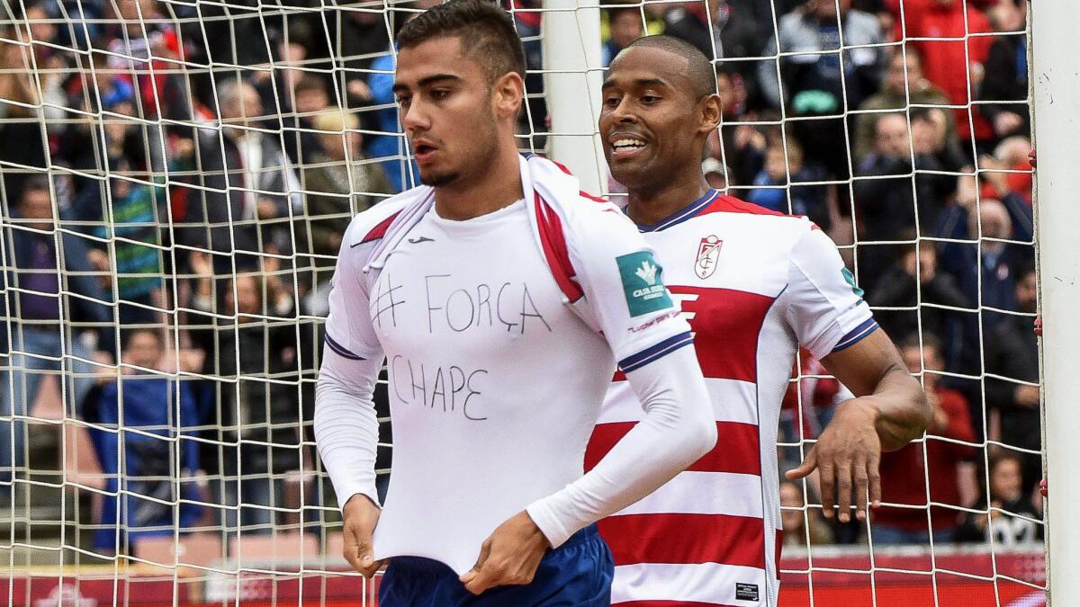 Granada midfielder Andreas Pereira celebrates after scoring a goal against Sevilla in a Spanish league game on Saturday by lifting his jersey to show a message of solidarity with the Chapecoense team.